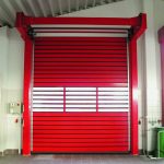 Red, high-speed, rigid, safety roller shutter door with a transparent viewing window